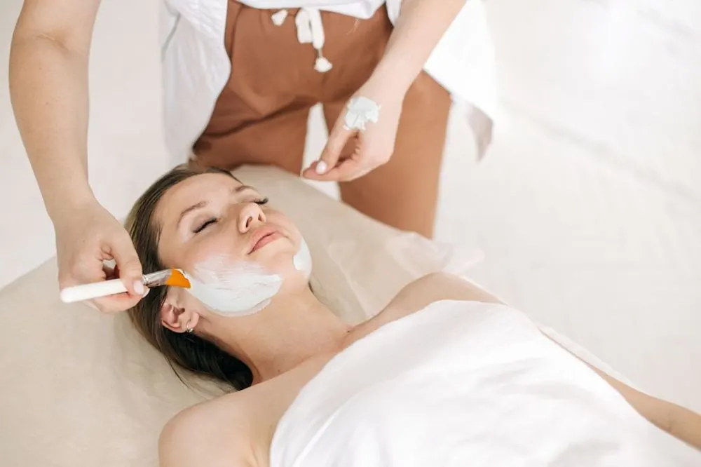 Facial mask being applied with a brush