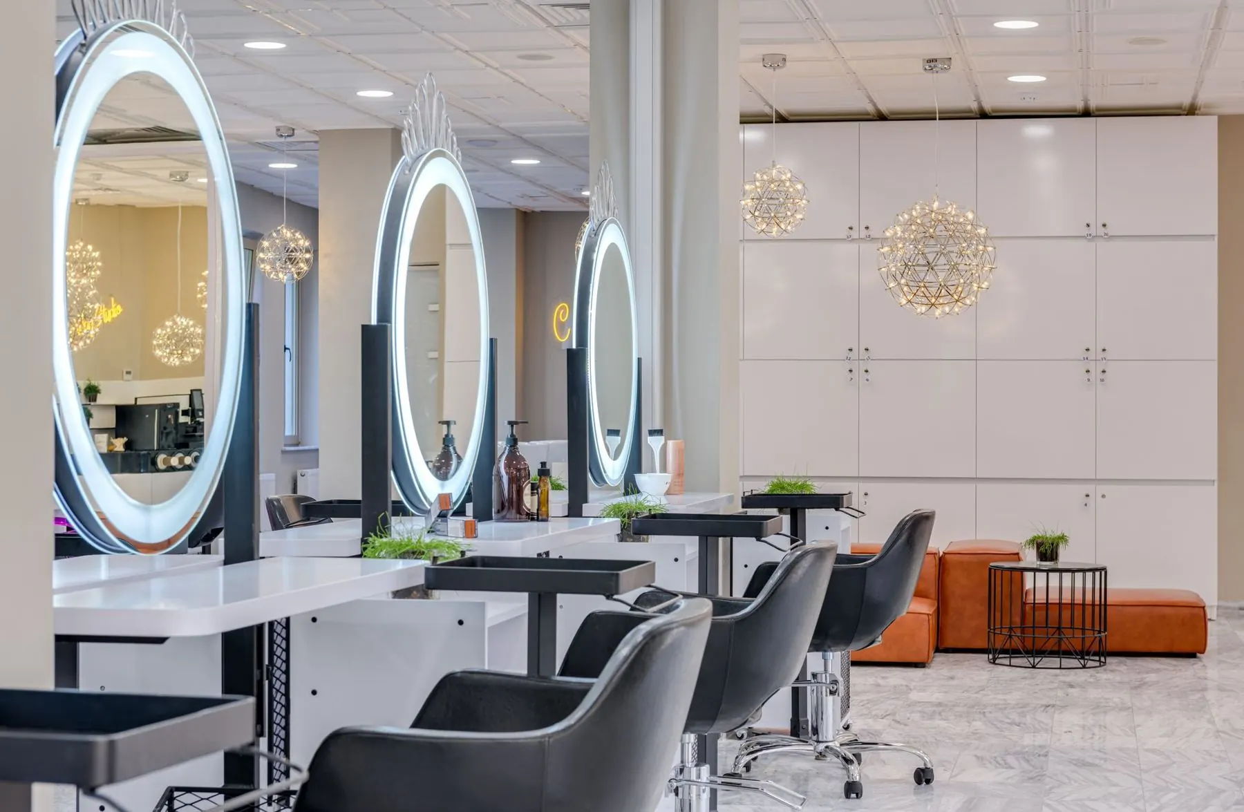 Bright beauty studio with round mirrors and treatment chairs