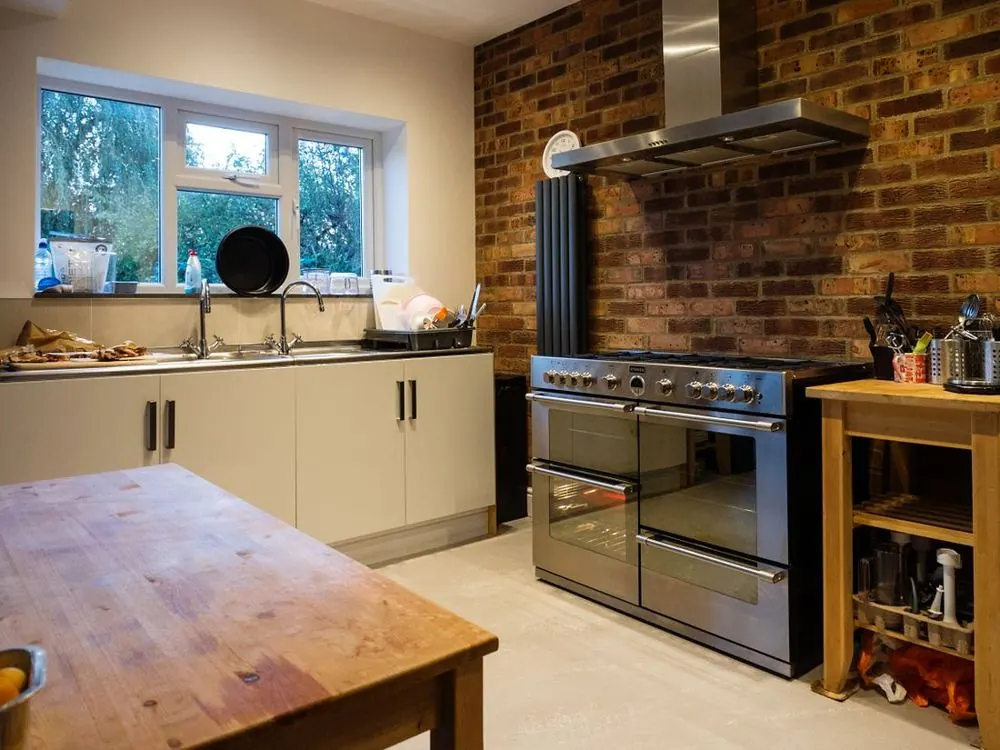 Finished kitchen with exposed brick wall
