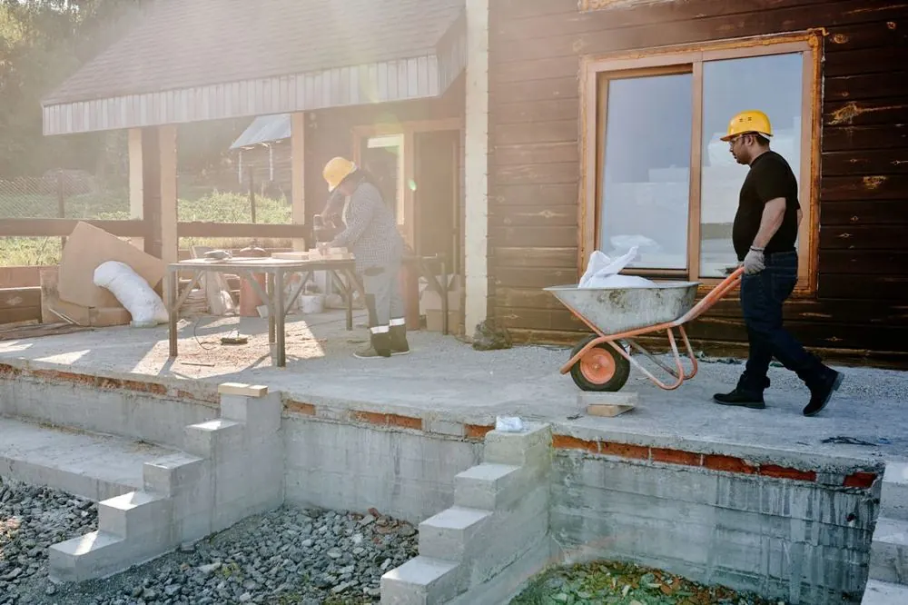Builders carrying materials on a house renovation
