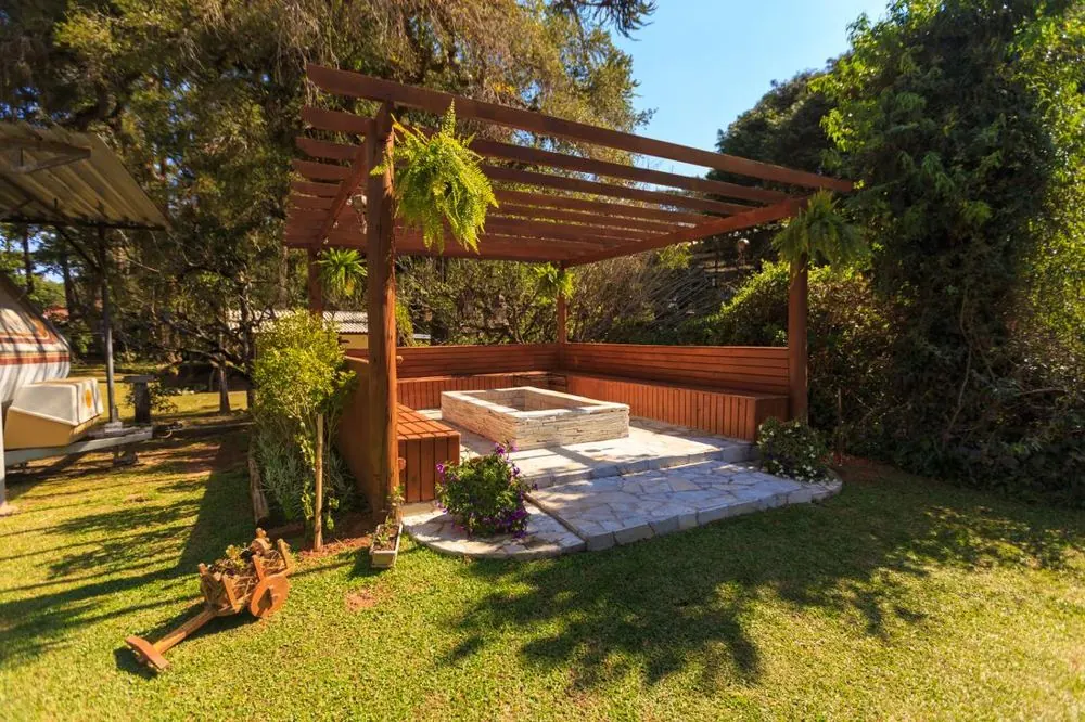 Garden with a wooden pergola, seating and lawn